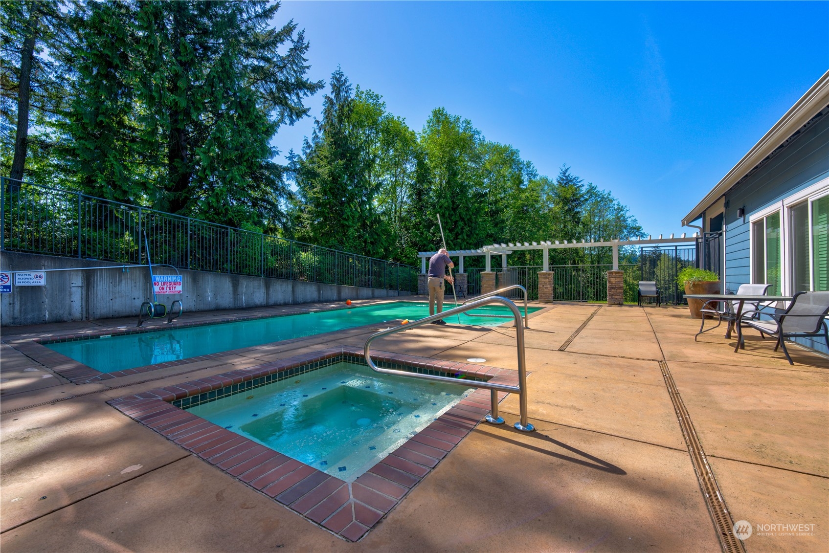 3908 243rd Place Southeast, Unit Q202 Bothell, WA 98021 - Photo 36 of 40 a view of a patio with lawn chairs plants and wooden fence
