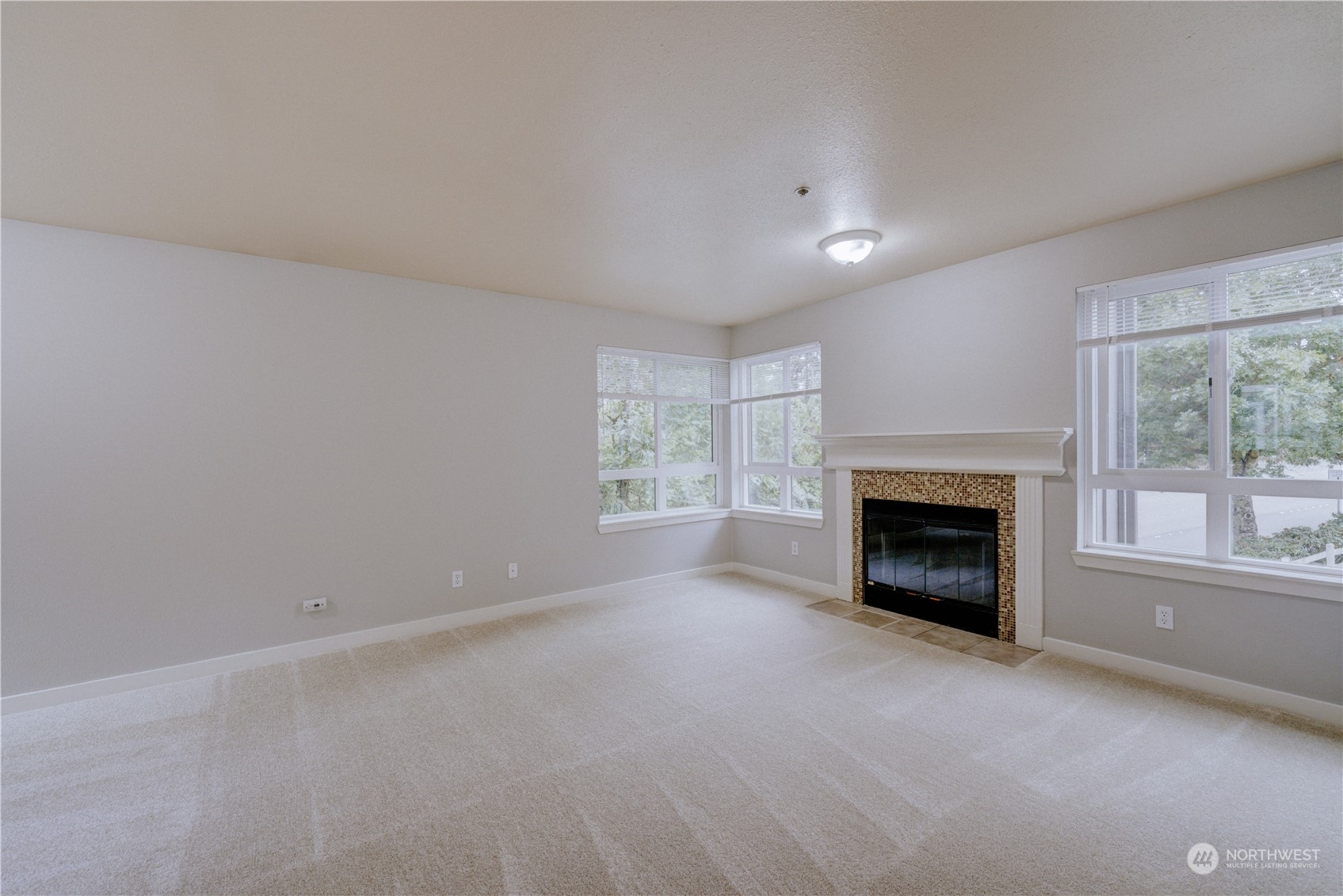 3908 243rd Place Southeast, Unit Q202 Bothell, WA 98021 - Photo 4 of 40 a view of empty room with a fireplace