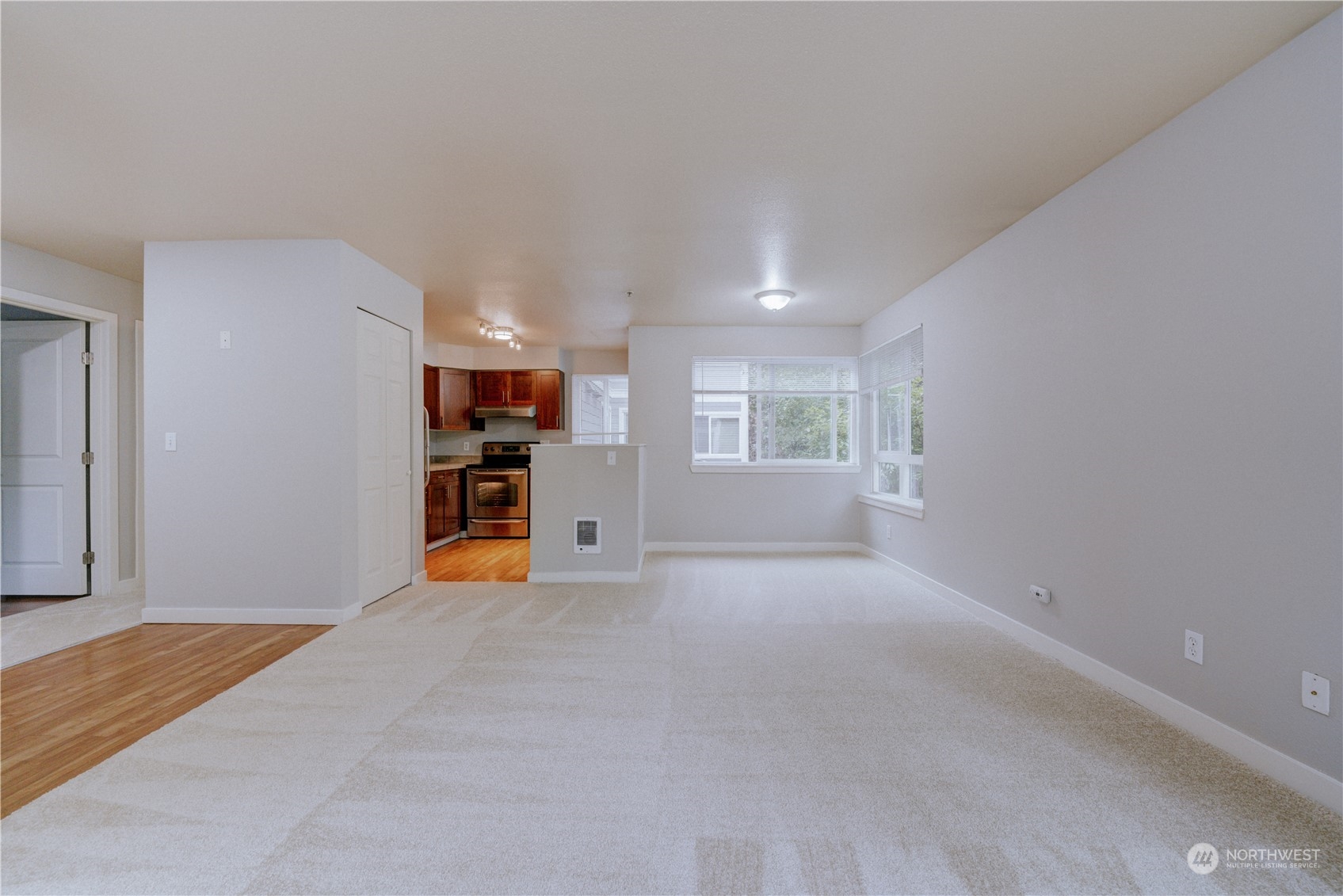 3908 243rd Place Southeast, Unit Q202 Bothell, WA 98021 - Photo 5 of 40 a view of empty room with furniture and kitchen view