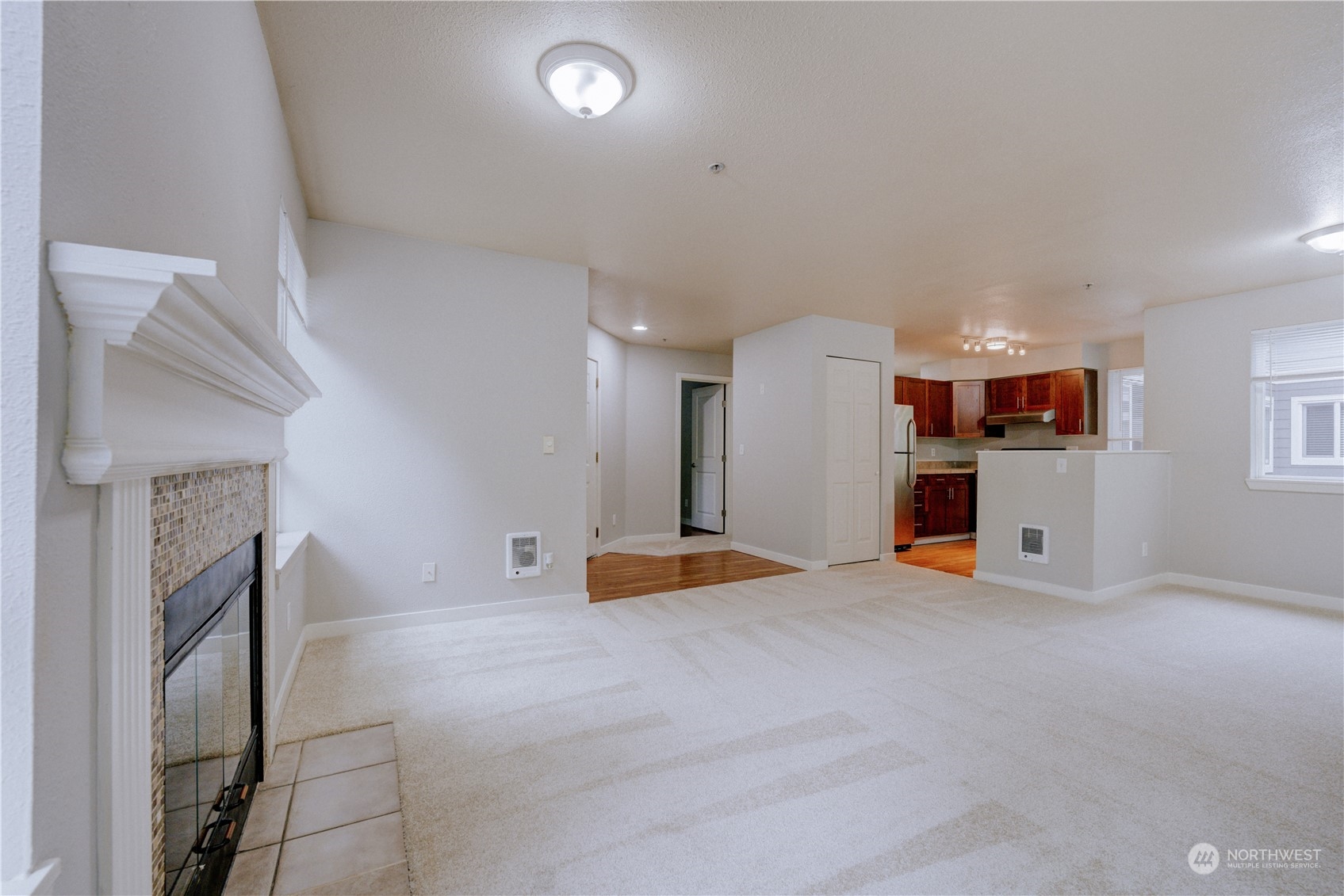3908 243rd Place Southeast, Unit Q202 Bothell, WA 98021 - Photo 6 of 40 a view of an empty room with a fireplace