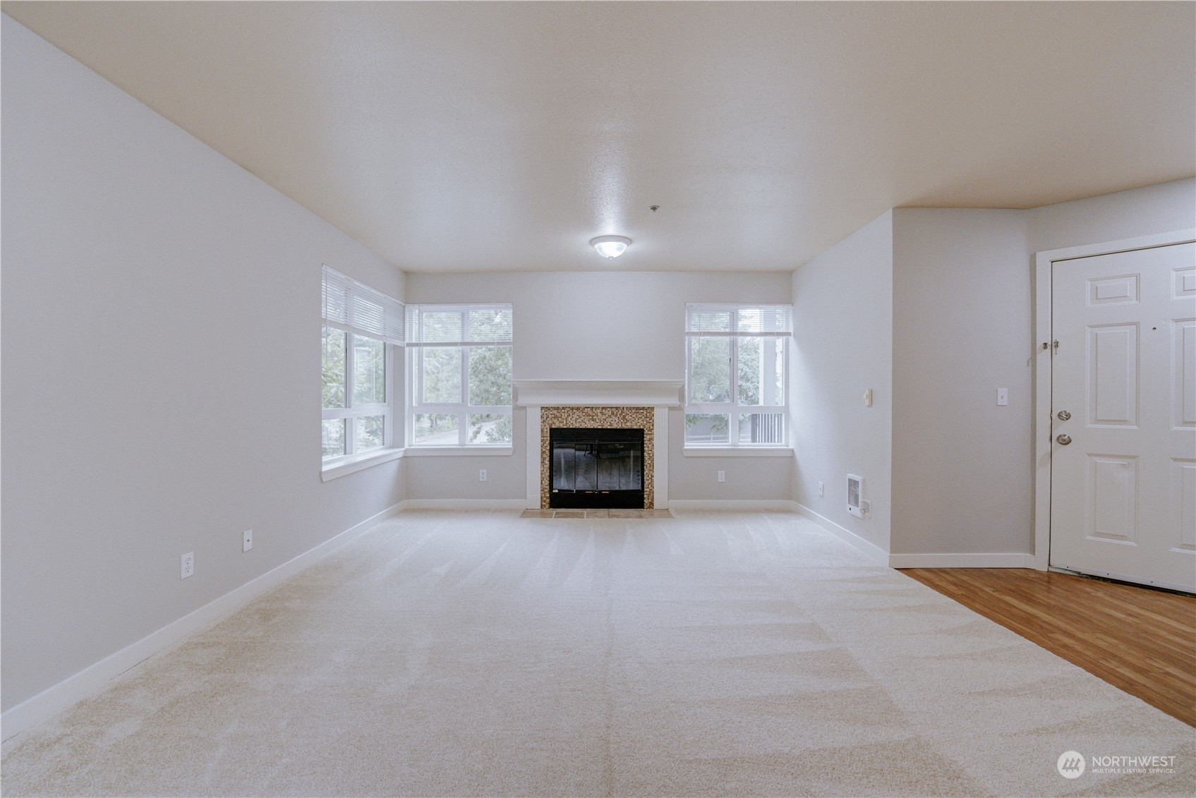 3908 243rd Place Southeast, Unit Q202 Bothell, WA 98021 - Photo 7 of 40 a view of empty room with a fireplace