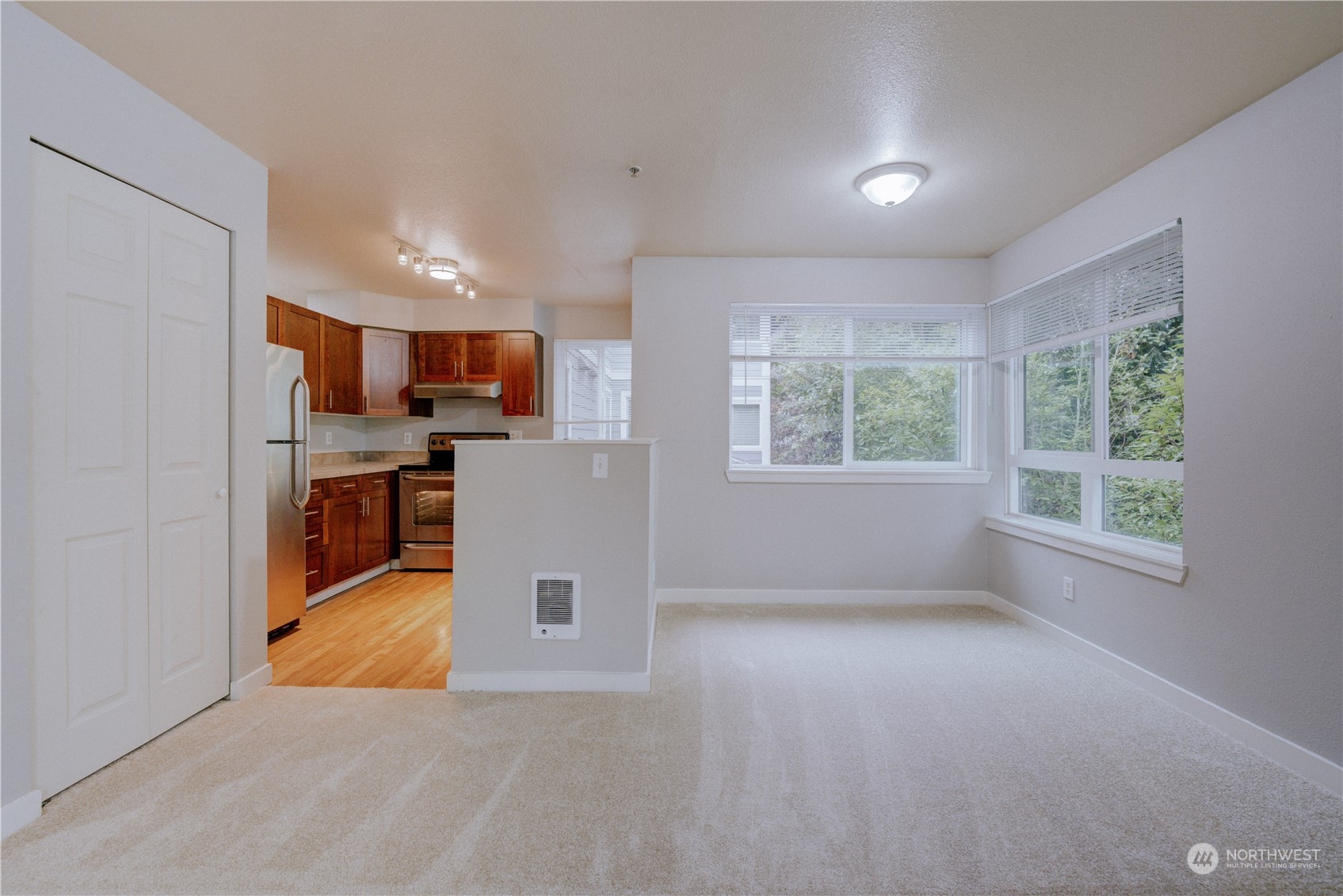 3908 243rd Place Southeast, Unit Q202 Bothell, WA 98021 - Photo 8 of 40 a kitchen with a refrigerator a stove top oven a sink and a window