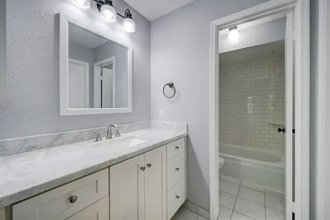 a bathroom with a double vanity sink and mirror