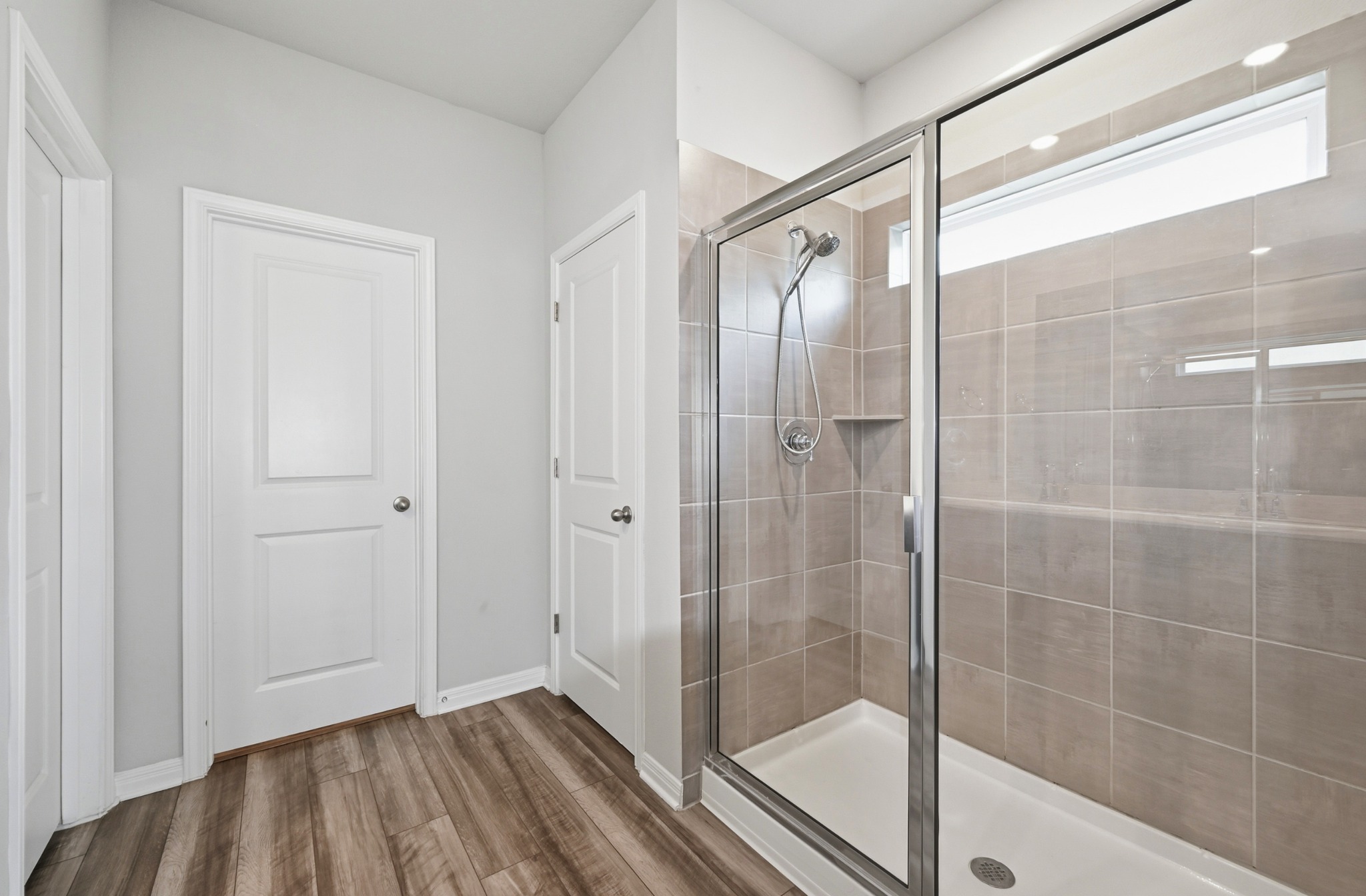 12606 Dairywork Road Buda, TX 78610 - Photo 18 of 32 a bathroom with a glass shower door