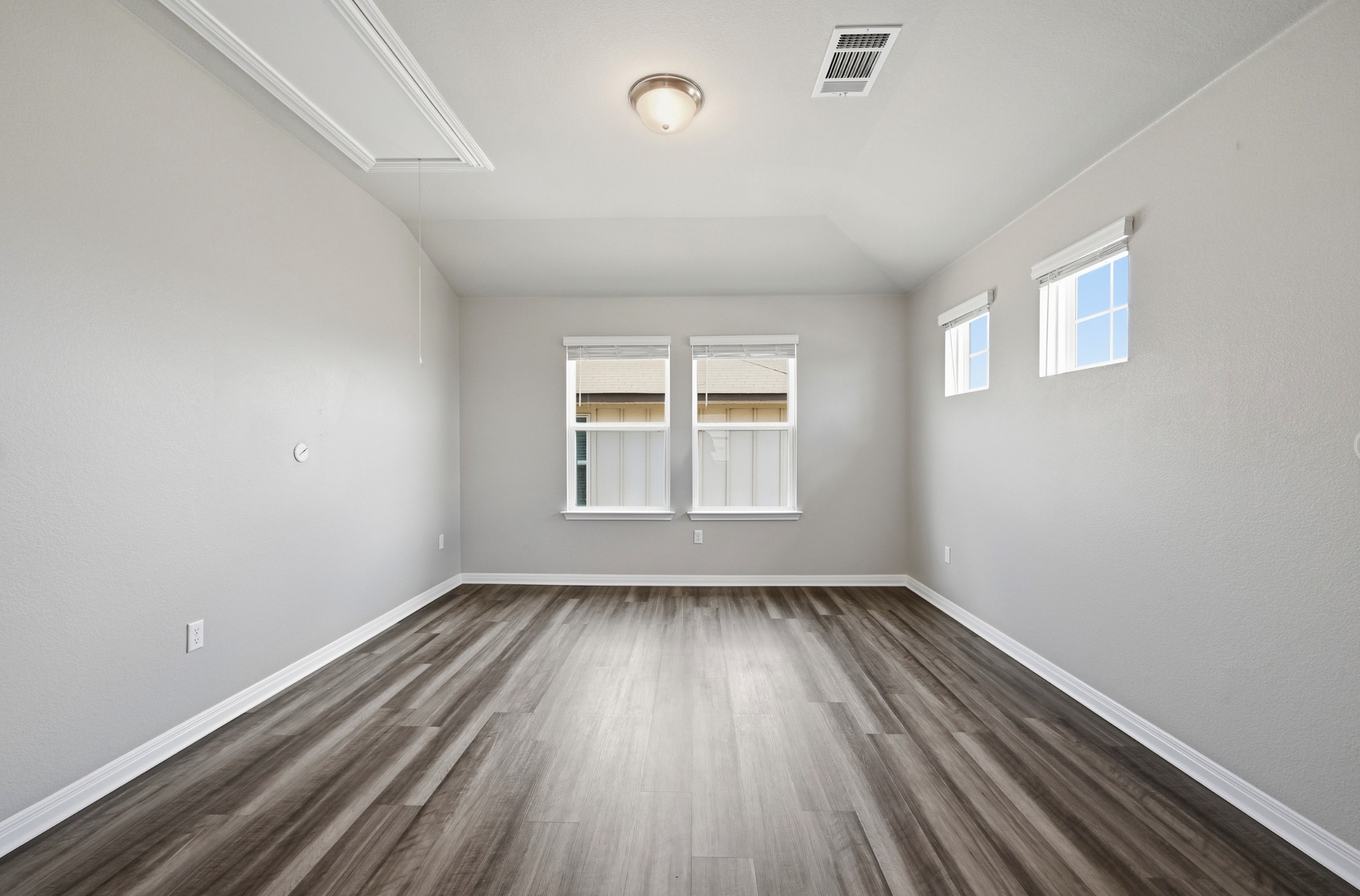12606 Dairywork Road Buda, TX 78610 - Photo 22 of 32 a view of an empty room with wooden floor and a window