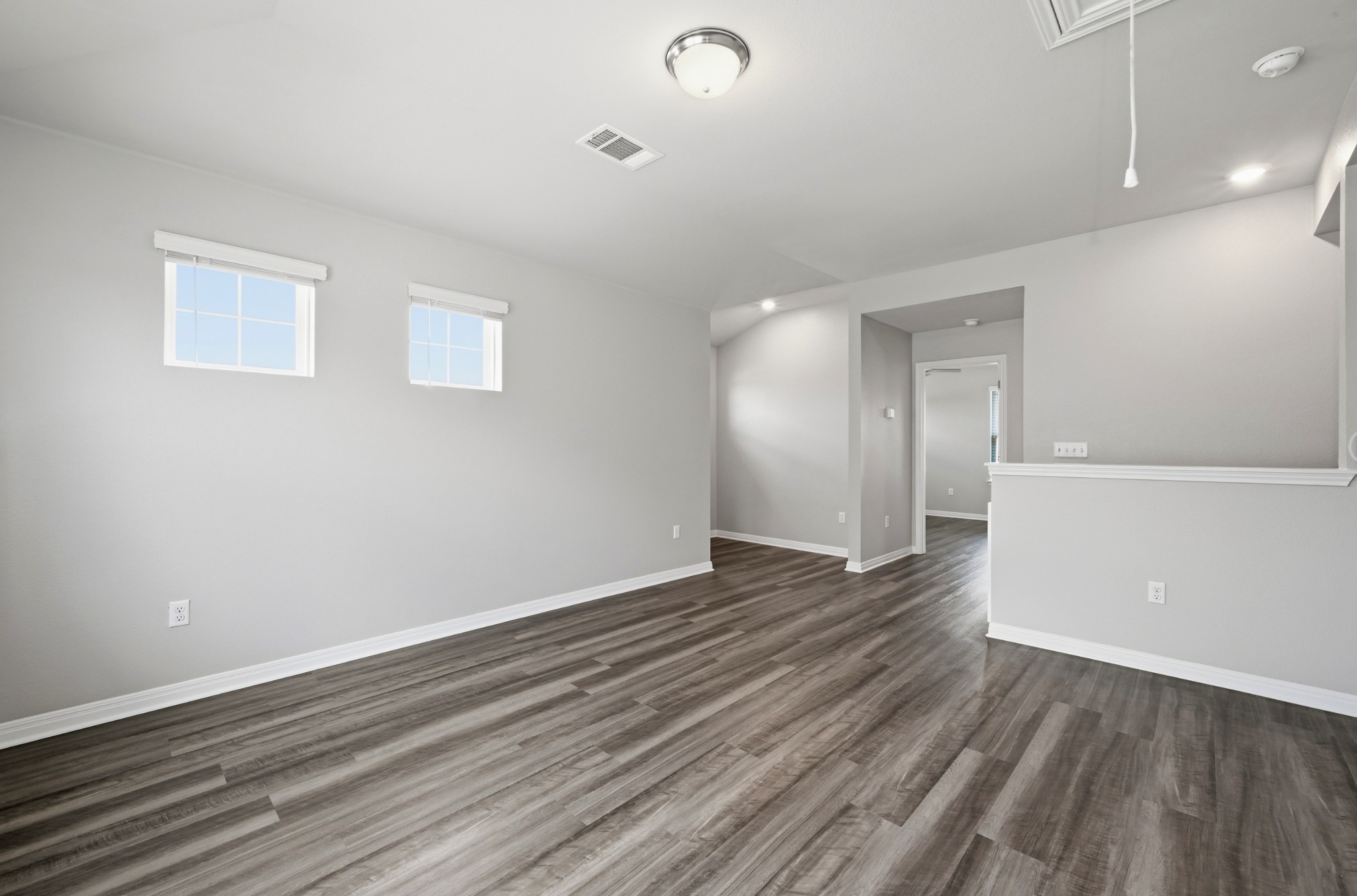 12606 Dairywork Road Buda, TX 78610 - Photo 23 of 32 a view of an empty room with wooden floor and a window