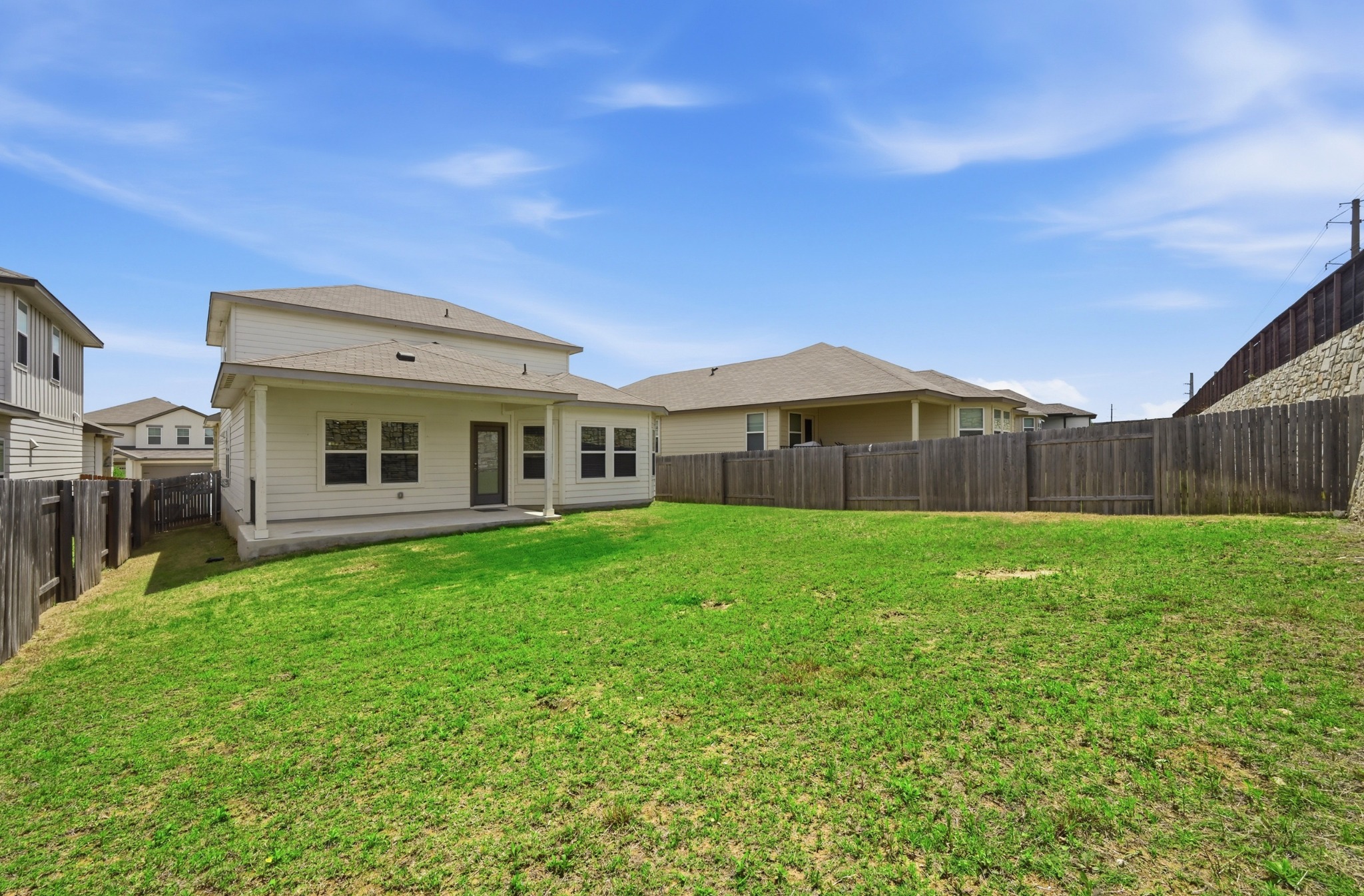 12606 Dairywork Road Buda, TX 78610 - Photo 30 of 32 a view of a house with a backyard