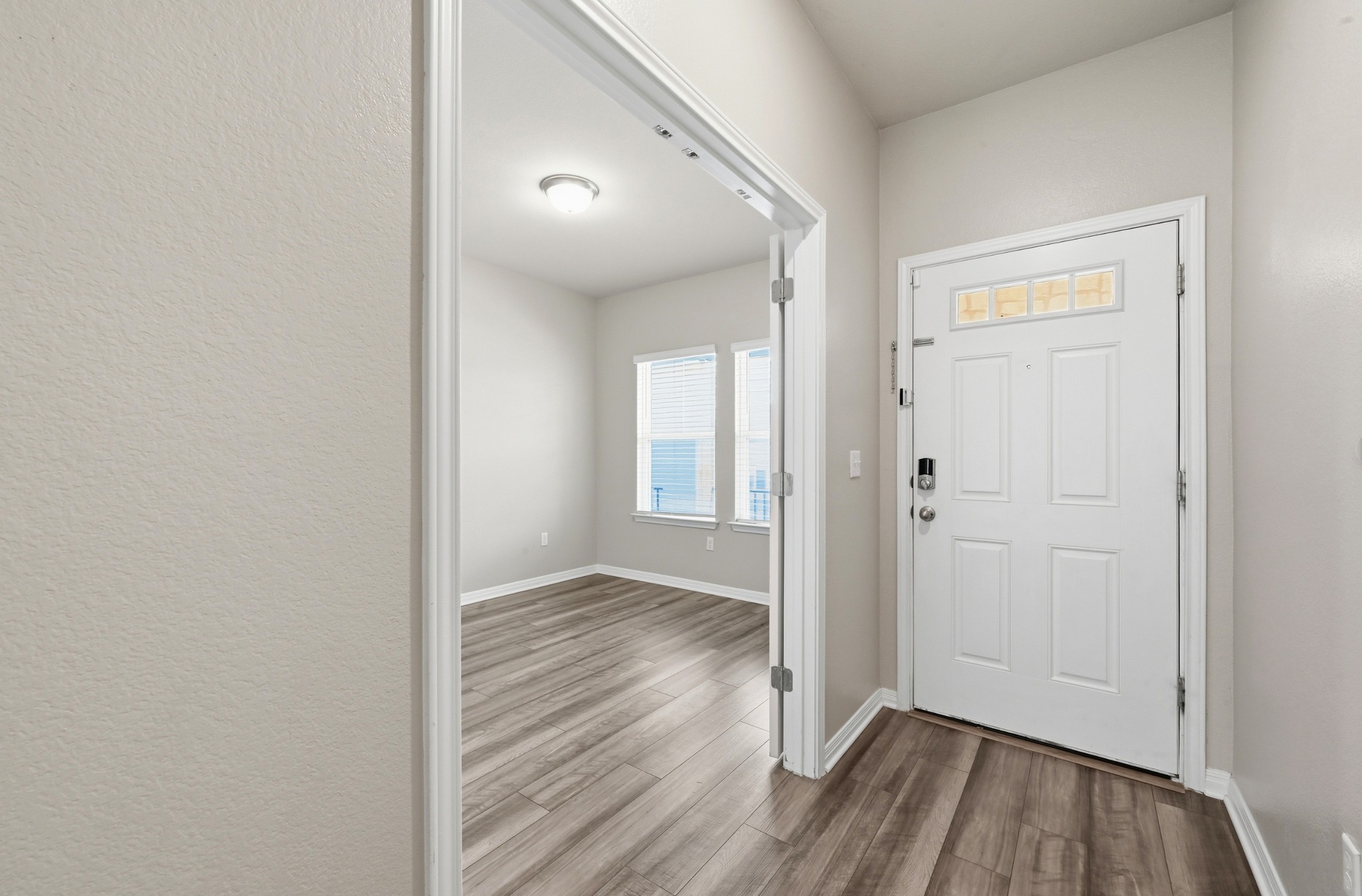 12606 Dairywork Road Buda, TX 78610 - Photo 5 of 32 an empty room with wooden floor and a ceiling fan