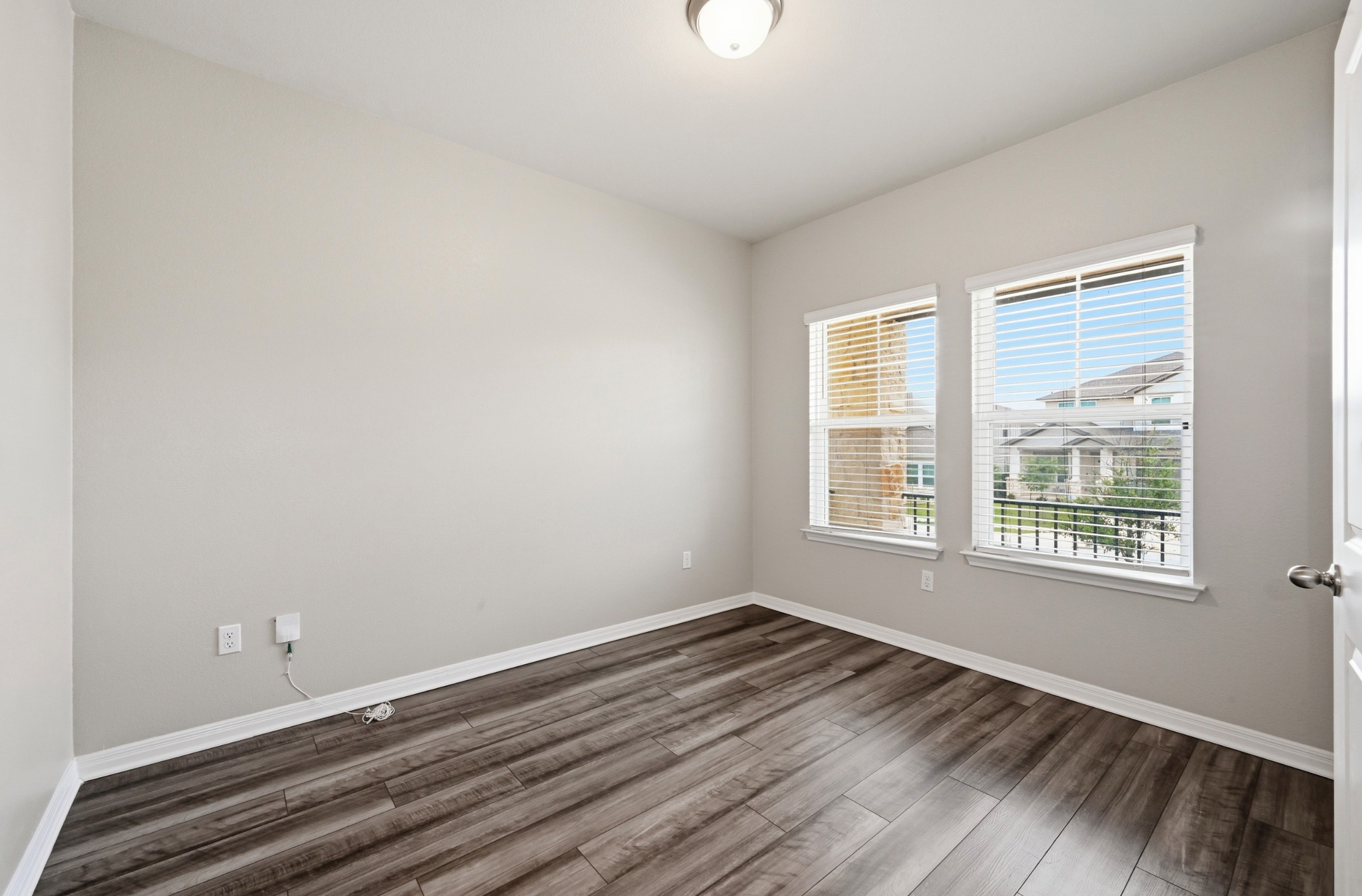 12606 Dairywork Road Buda, TX 78610 - Photo 6 of 32 an empty room with wooden floor and windows