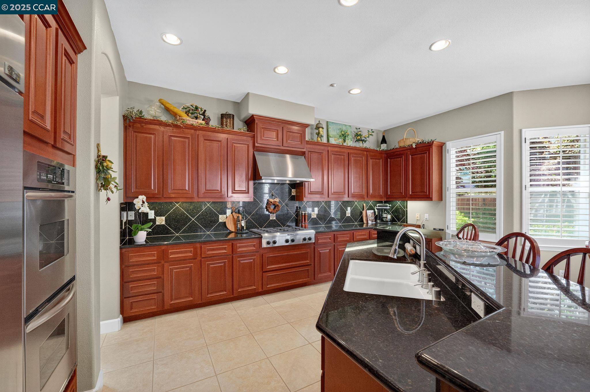 255 Prato Way Livermore, CA 94550 - Photo 17 of 45 a kitchen with stainless steel appliances granite countertop a sink stove and refrigerator