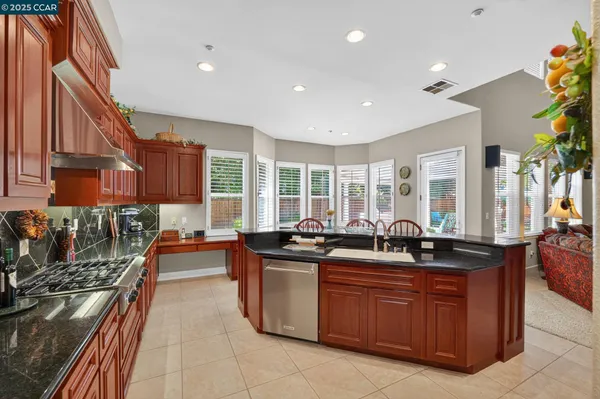 a kitchen with granite countertop a sink and stove