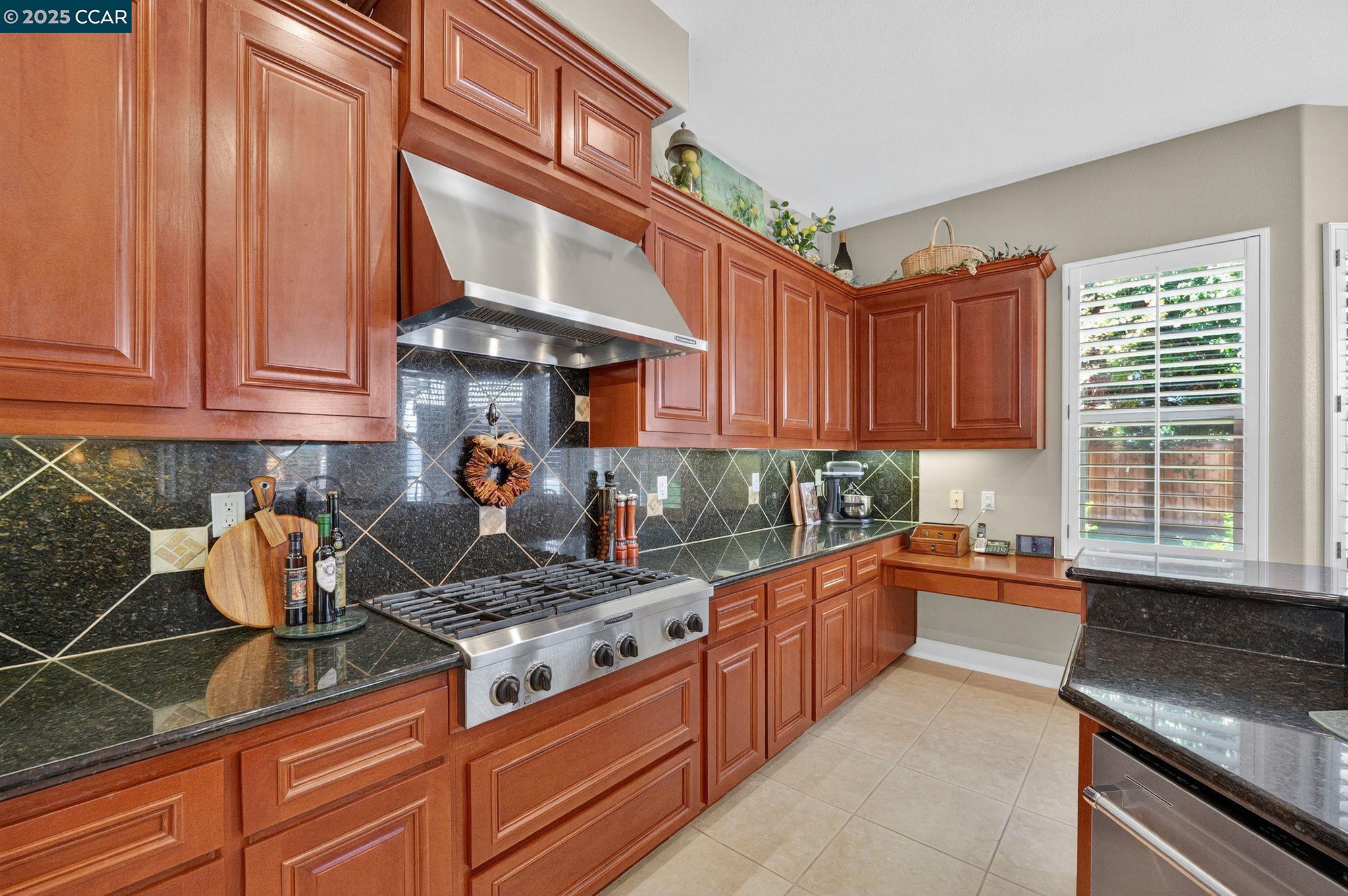 255 Prato Way Livermore, CA 94550 - Photo 20 of 45 a kitchen with stainless steel appliances granite countertop a stove a sink and a microwave