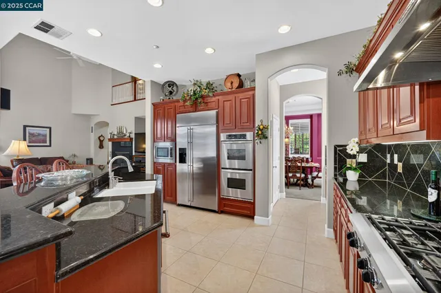 a kitchen with refrigerator and cabinets