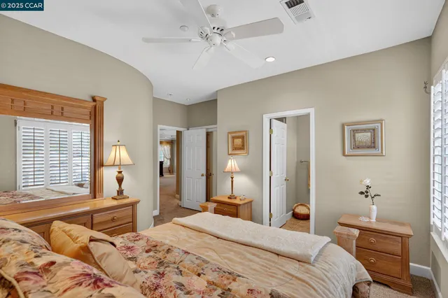 a bedroom with a bed and a chair