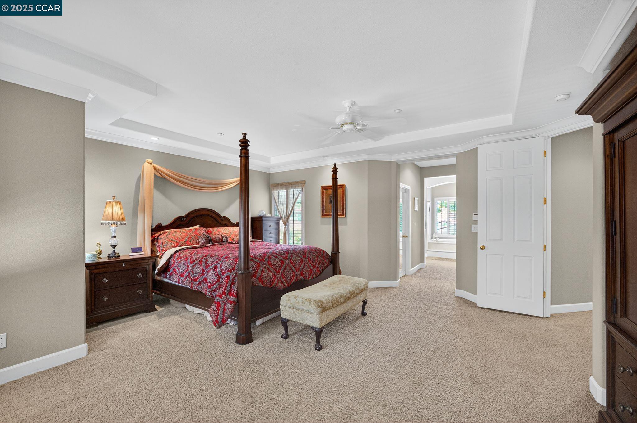 255 Prato Way Livermore, CA 94550 - Photo 30 of 45 a spacious bedroom with a bed and a chandelier