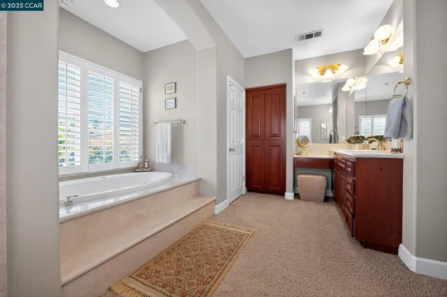a large spacious bathroom with a large tub and shower