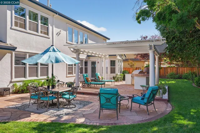 a view of a house with backyard porch and sitting area