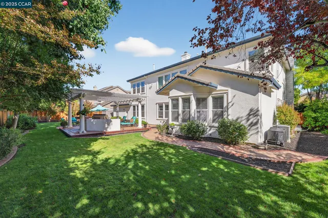 a front view of a house with a yard table and chairs