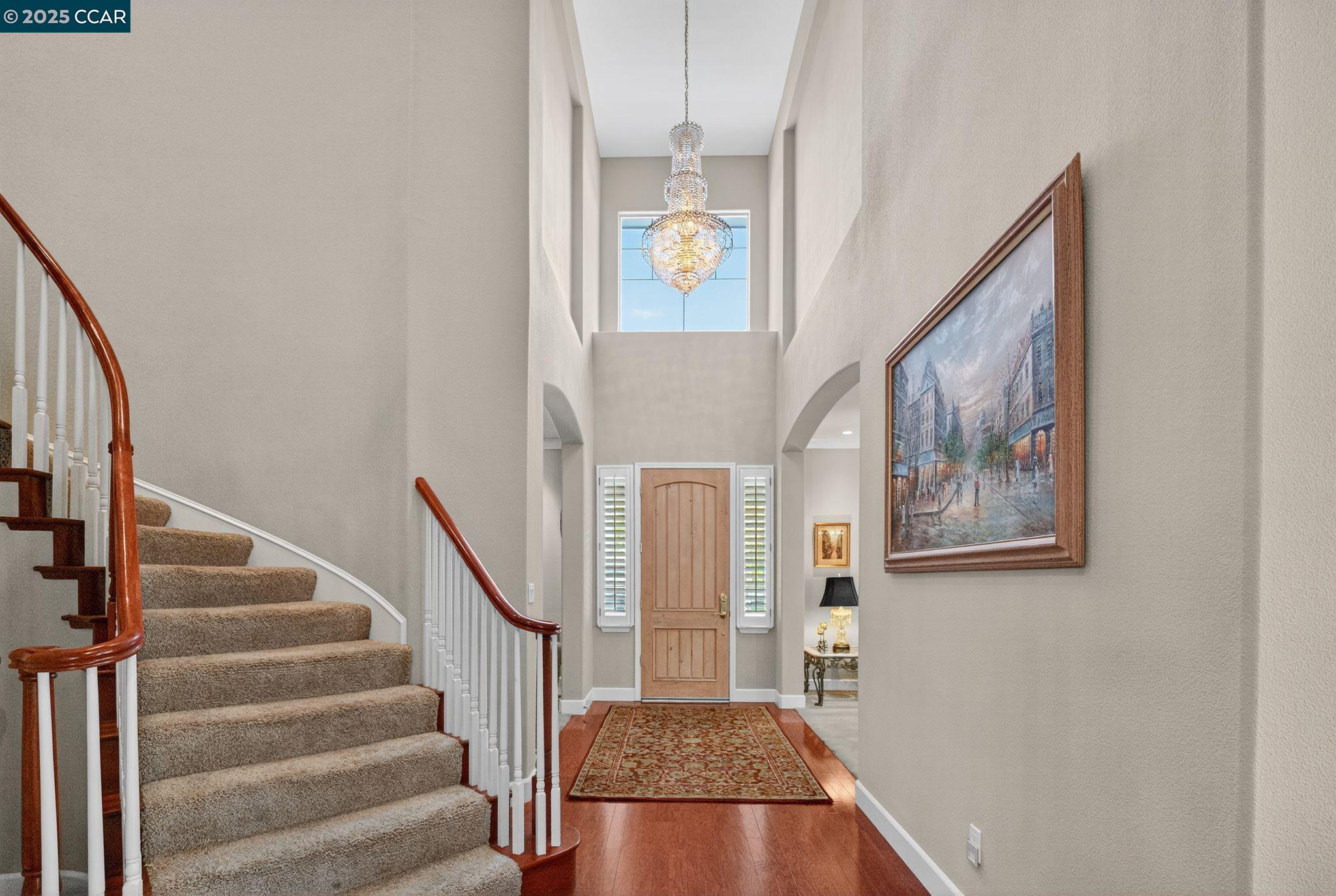 255 Prato Way Livermore, CA 94550 - Photo 5 of 45 a view of a hallway with wooden floor and staircase