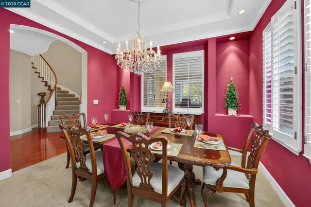 a view of a dining room with furniture and chandelier
