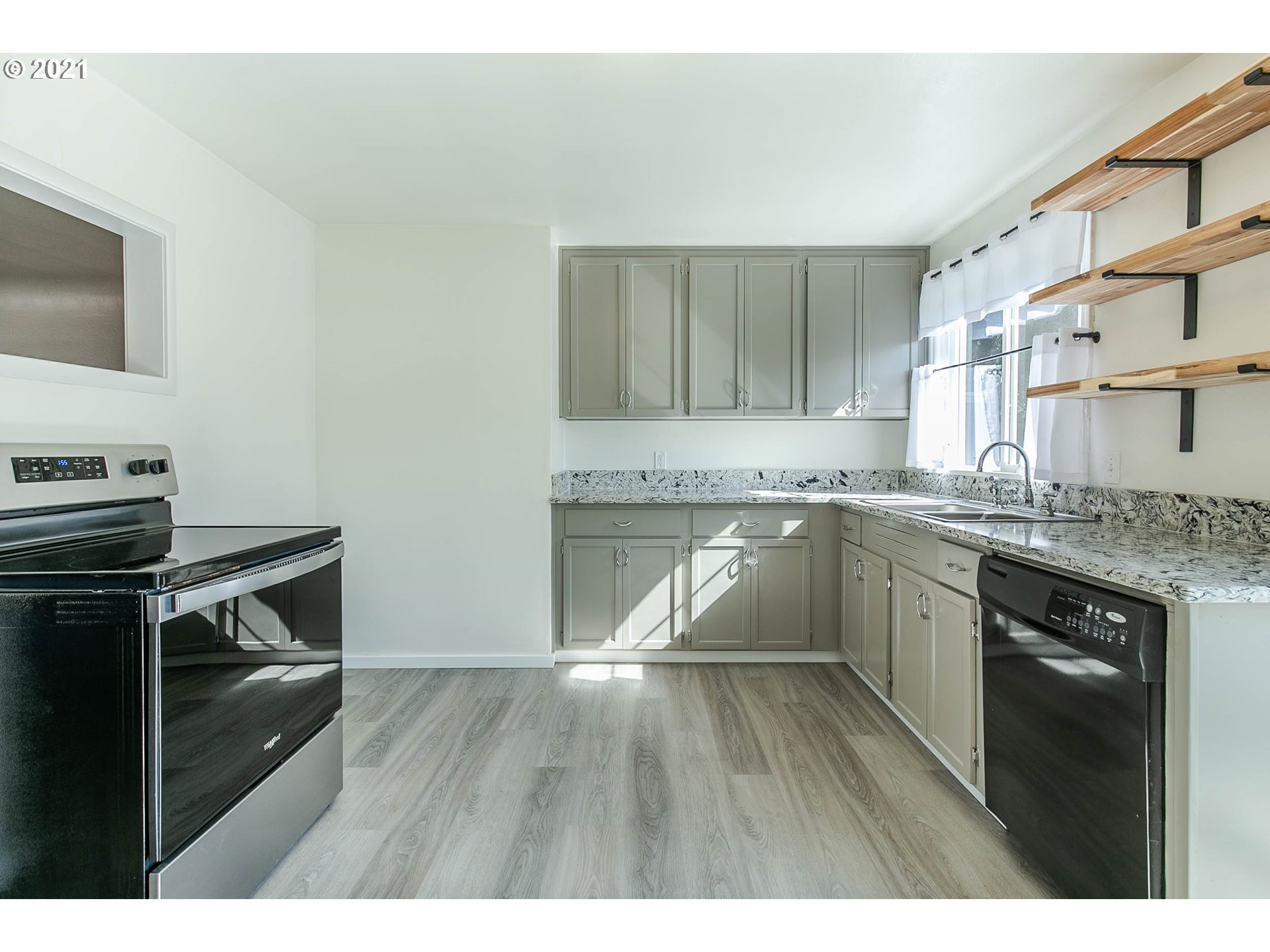 1469 Parker Street Springfield, OR 97477 - Photo 14 of 30 a kitchen with a sink stove and cabinets