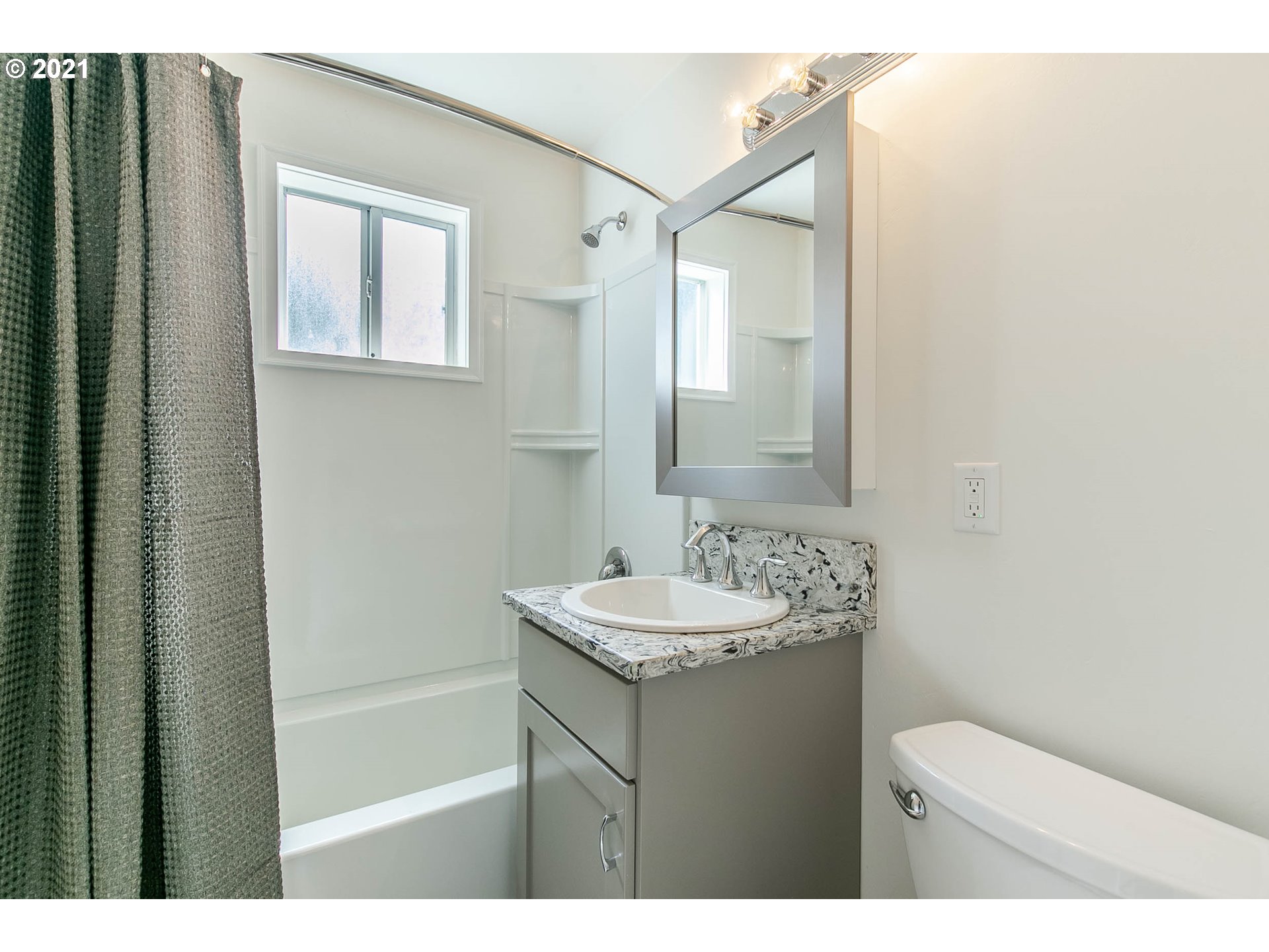 1469 Parker Street Springfield, OR 97477 - Photo 21 of 30 a bathroom with a sink toilet and mirror