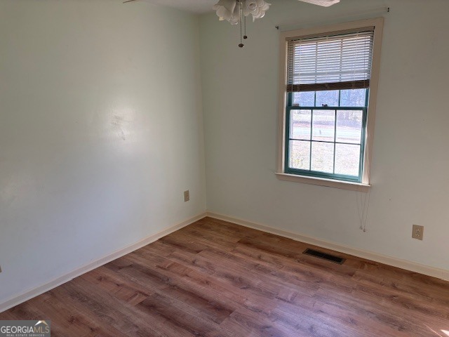 2395 High Falls Road Griffin, GA 30223 - Photo 13 of 20 an empty room with wooden floor and windows