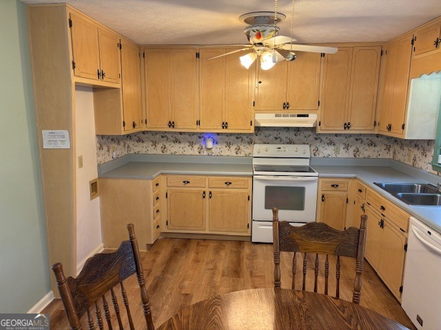 2395 High Falls Road Griffin, GA 30223 - Photo 5 of 20 a kitchen with stainless steel appliances granite countertop a stove a sink dishwasher and a refrigerator with wooden floor