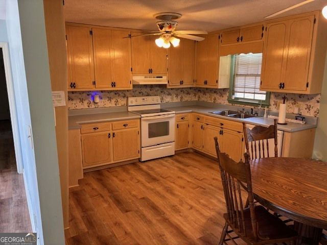 2395 High Falls Road Griffin, GA 30223 - Photo 6 of 20 a kitchen with stainless steel appliances granite countertop a stove a sink and a refrigerator