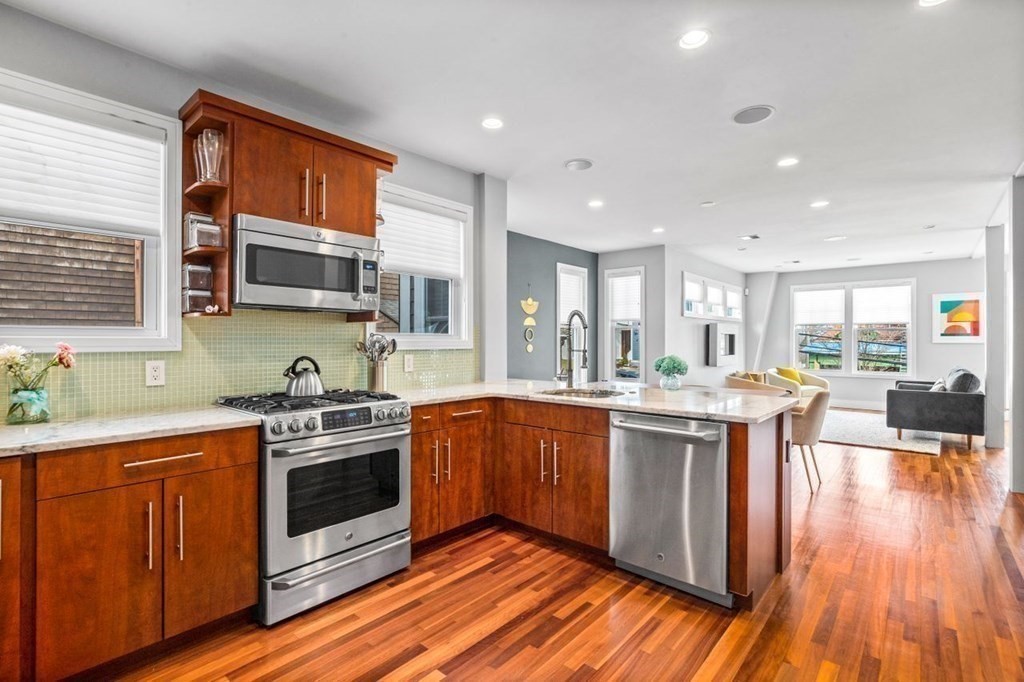 80 Summit Avenue, Unit 80 Brookline, MA 02446 - Photo 11 of 41 a large kitchen with stainless steel appliances granite countertop a stove and a sink