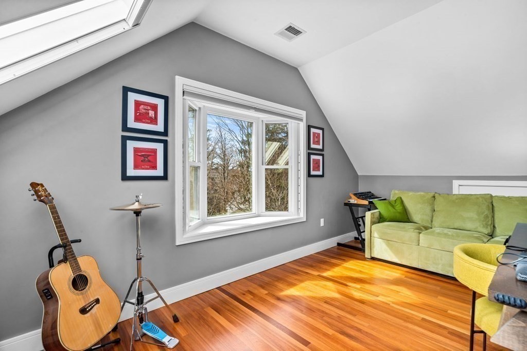 80 Summit Avenue, Unit 80 Brookline, MA 02446 - Photo 22 of 41 a living room with furniture a window and gym equipment