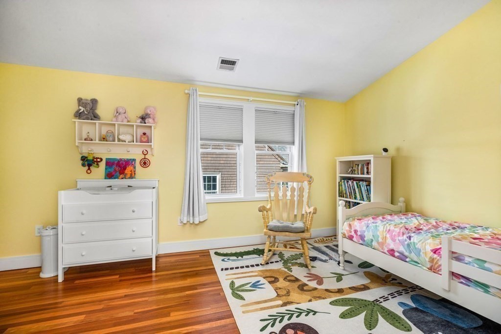 80 Summit Avenue, Unit 80 Brookline, MA 02446 - Photo 25 of 41 a bedroom with a bed and wooden floor