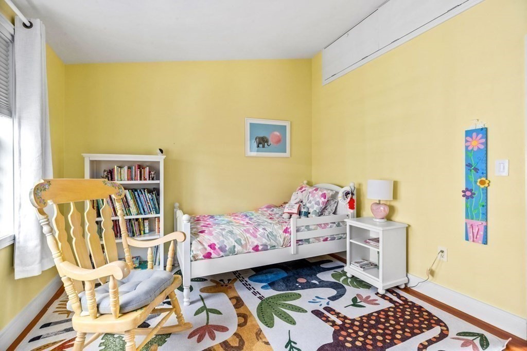 80 Summit Avenue, Unit 80 Brookline, MA 02446 - Photo 26 of 41 a bedroom with a bed and wooden floor