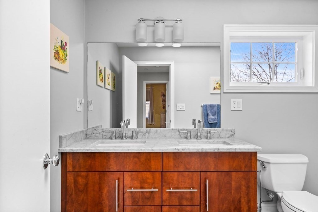 80 Summit Avenue, Unit 80 Brookline, MA 02446 - Photo 27 of 41 a bathroom with a granite countertop sink and a mirror