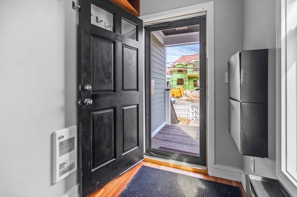 80 Summit Avenue, Unit 80 Brookline, MA 02446 - Photo 3 of 41 a view of a hallway with wooden floor and staircase