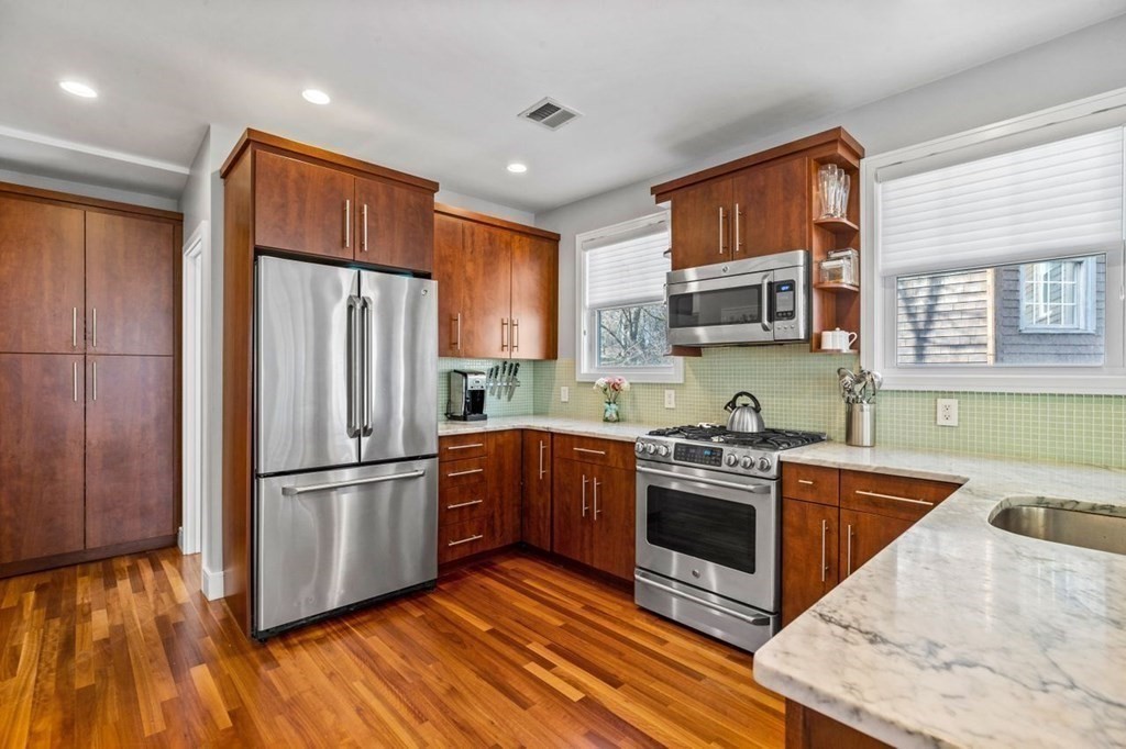80 Summit Avenue, Unit 80 Brookline, MA 02446 - Photo 5 of 41 a kitchen with stainless steel appliances granite countertop a refrigerator a stove a sink dishwasher and a refrigerator with wooden floor