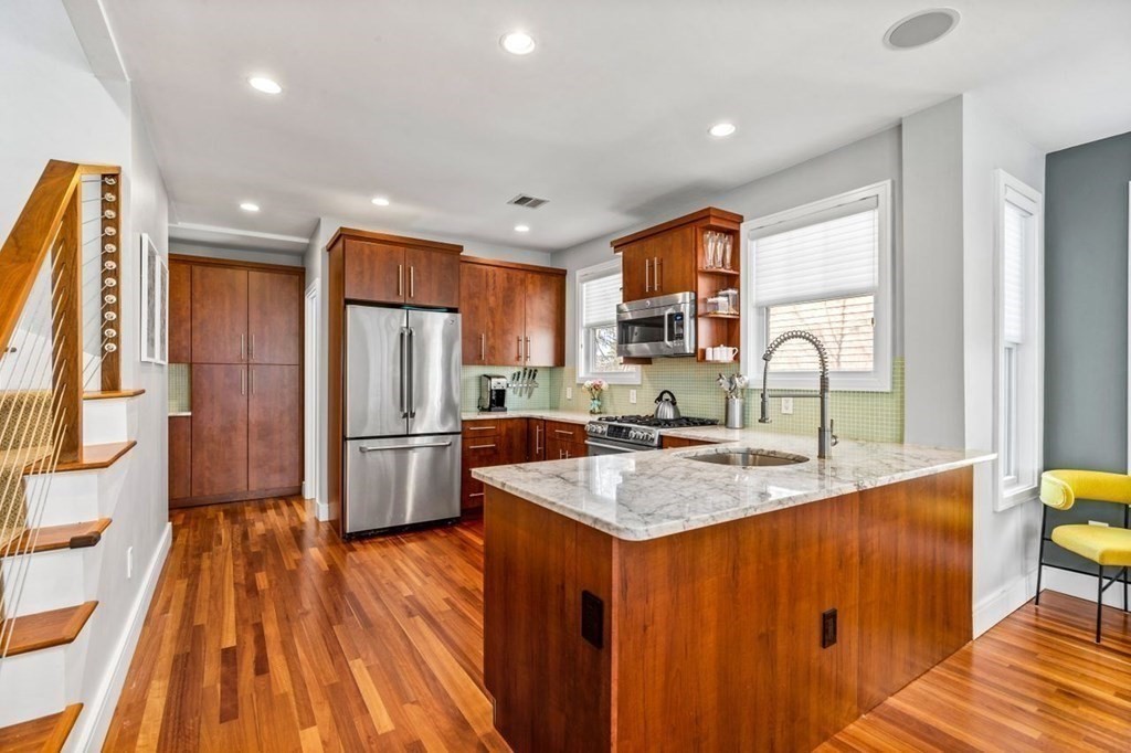 80 Summit Avenue, Unit 80 Brookline, MA 02446 - Photo 6 of 41 a kitchen with stainless steel appliances granite countertop a refrigerator a sink dishwasher a stove with wooden cabinets and floor