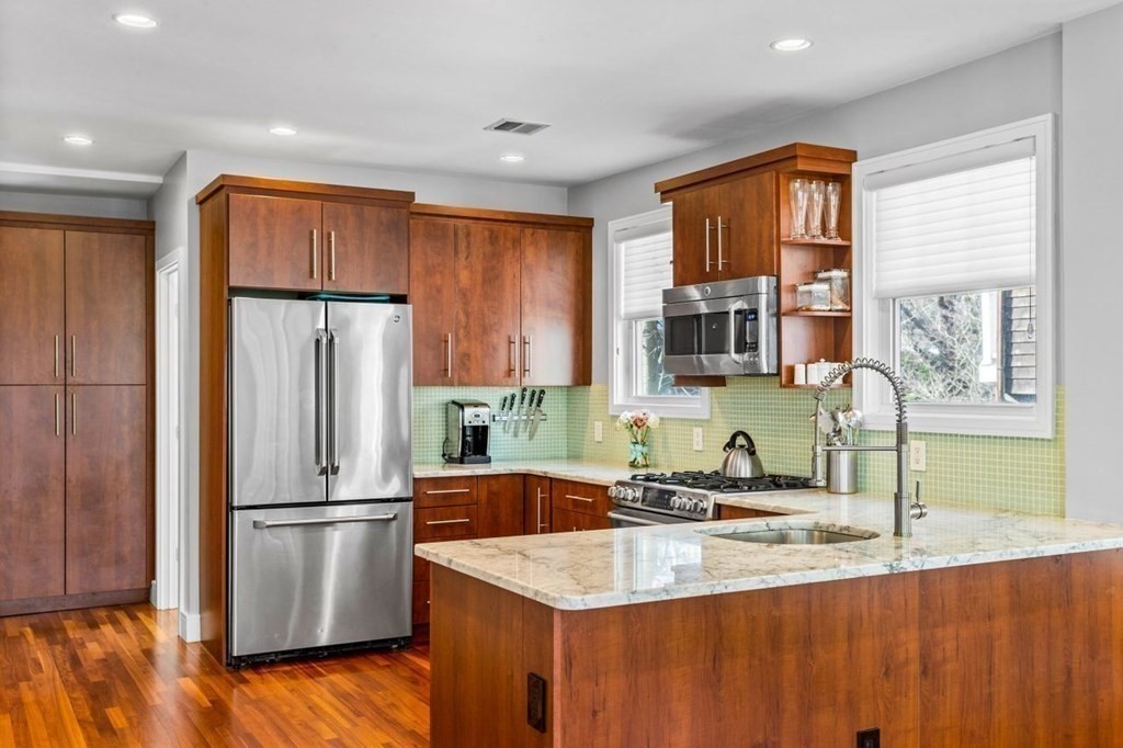 80 Summit Avenue, Unit 80 Brookline, MA 02446 - Photo 8 of 41 a kitchen with stainless steel appliances granite countertop a refrigerator a sink a stove a washer dryer and white cabinets