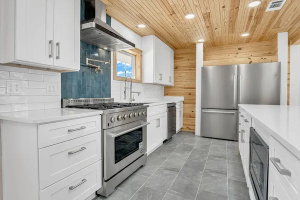 a kitchen with a stove oven and a refrigerator