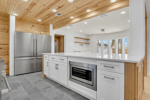 a kitchen with stainless steel appliances a refrigerator sink and cabinets