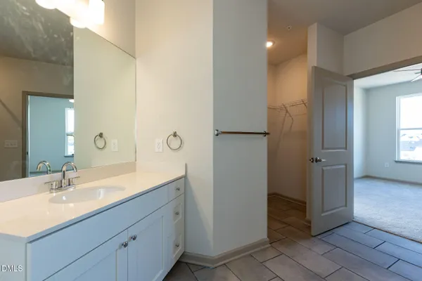 a spacious bathroom with a double vanity sink and mirror