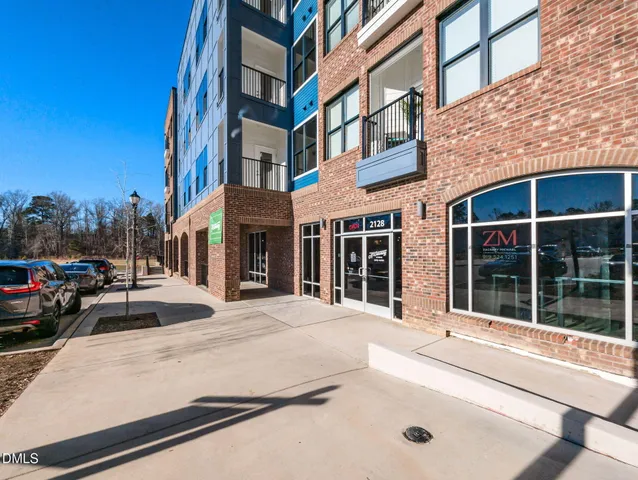 a view of a building with car parked