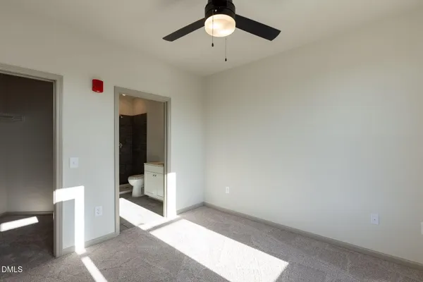 a view of an empty room and bathroom