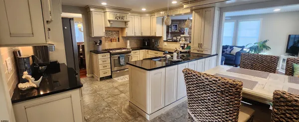 a kitchen with a sink appliances and cabinets