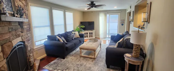 a living room with furniture a flat screen tv and a fireplace