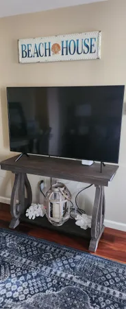 a living room with furniture and flat screen tv