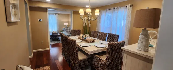 a view of a dining room with furniture and chandelier