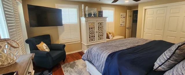 a bedroom with bed and mirror