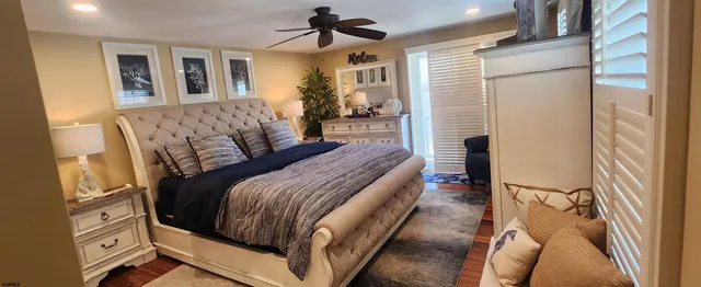 a bedroom with a bed couch and a window