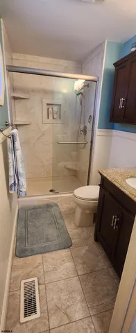 a bathroom with a toilet and a shower